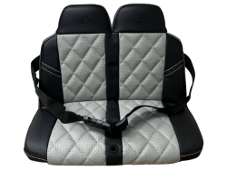 The 12V Mercedes-Maybach G650 4×4 seat cover features a quilted diamond pattern in gray and black with a central black strap and buckle, reinforced headrest areas, and white stitching accents. For inquiries or customizations, contact us today!.