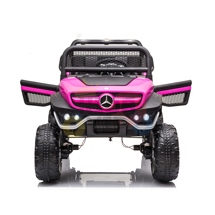 Front view of a Pink 12V/4X4 Official Mercedes Unimog Junior Ride On UTV, resembling a Mercedes-Benz jeep with large wheels, grille guard, and LED lights on a reflective white background—ideal for little adventurers dreaming of their own ride.