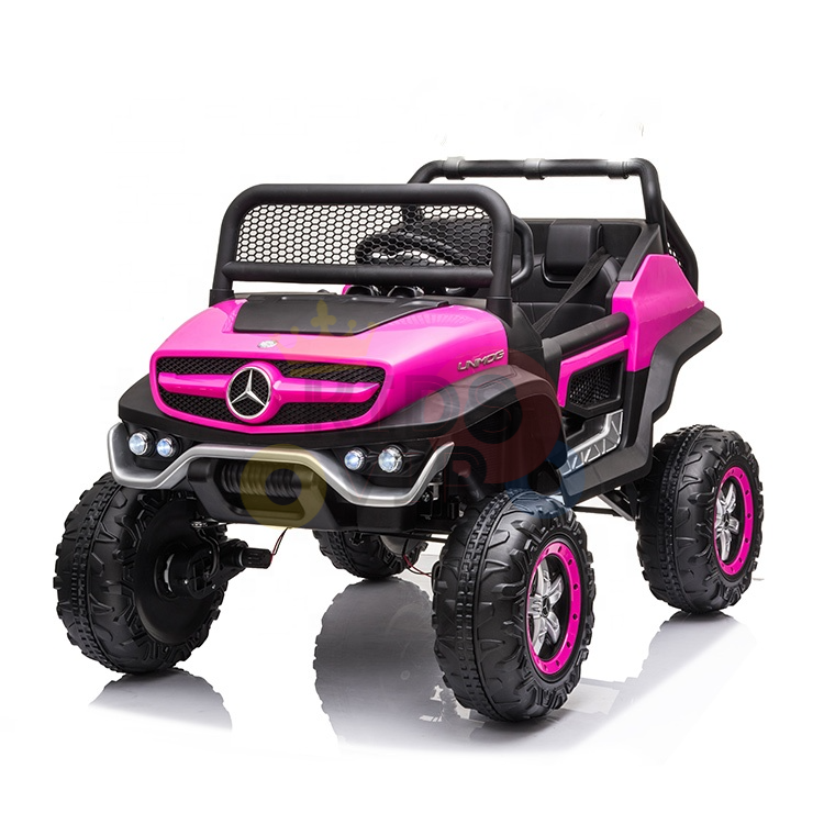 The Pink 12V/4X4 Official Mercedes Unimog Junior Ride On UTV resembles an off-road vehicle with a prominent front grille, large rugged wheels, luxury car elements, and a seating area for children.