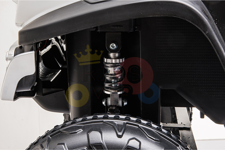 Detailed suspension system close-up of a Pink 12V/4X4 Official Mercedes Unimog Junior Ride On UTV, showing coiled spring and shock absorber above a rugged tire. Metal and plastic components with chrome accents highlight this precision-engineered kids ride-on car.