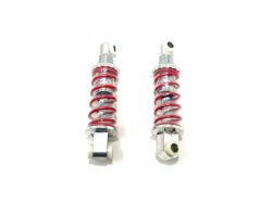 Displayed against a white background, the 12V UTV Sport XMX Suspension Shocks feature two silver bodies with vibrant red springs and mounting points at each end. Ideal for ride on cars, they are final sale items. Contact us for more details!.