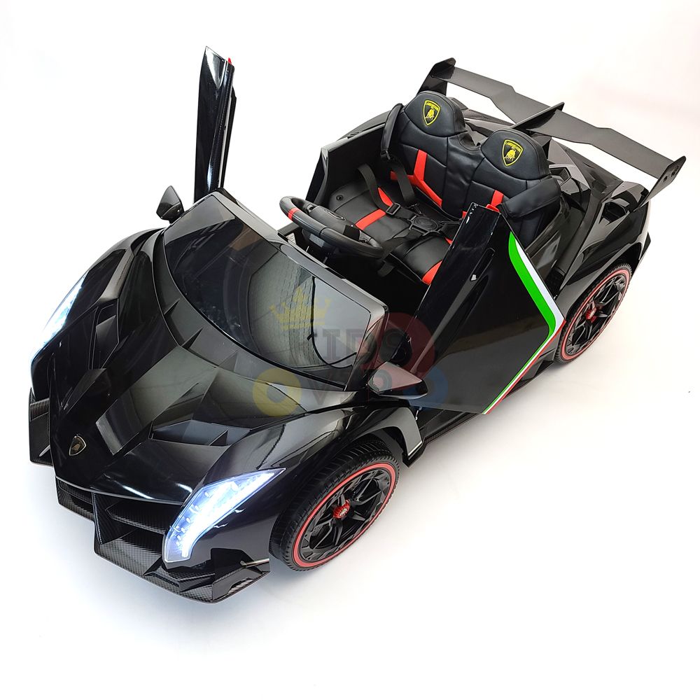 A sleek black Black 2X12V Limited Edition 4WD Lamborghini Veneno Ride on Car, RC features open scissor doors, red accents, a detailed interior, bright headlights, and a sporty design. This luxury sports car-style 2-seater ride-on is positioned on a white background.