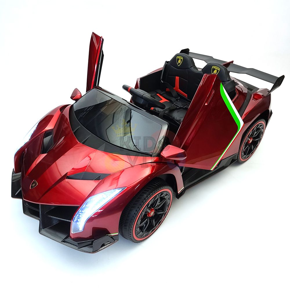 The Red 2X12V Limited Edition 4WD Lamborghini Veneno Ride on Car, RC features a sleek sporty design with open scissor doors, racing stripes, LED headlights, and a black interior complete with a steering wheel.