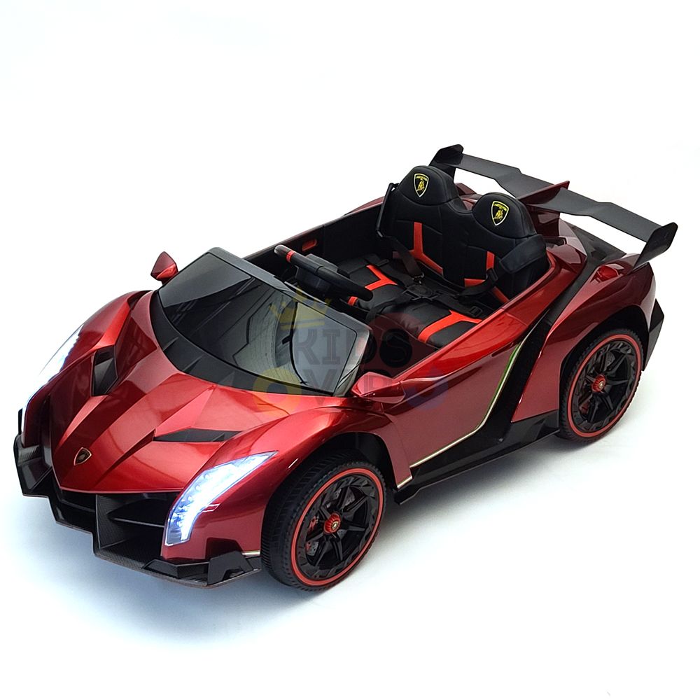 The Red 2X12V Limited Edition 4WD Lamborghini Veneno Ride on Car, RC is a shiny red convertible toy sports car with black accents, a detailed interior, sleek features like visible headlights and a prominent rear wing, and logos on the headrests.