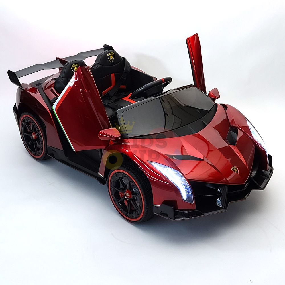 The Red 2X12V Limited Edition 4WD Lamborghini Veneno Ride on Car, RC flaunts open scissor doors, sleek black seats, and stylish black and red wheels. Perfectly capturing a stunning look against a white background, this ride-on is a captivating toy sports car.