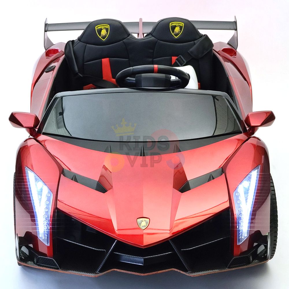 Introducing the Red 2X12V Limited Edition 4WD Lamborghini Veneno Ride on Car, RC: a stylish red toy sports car featuring sleek lines, LED front lights, black leather-like seats with the brand logo, a steering wheel, and rear spoiler. Enjoy added safety and fun with parental remote control.