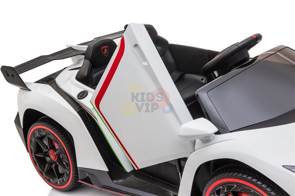 A white 2X12V Limited Edition 4WD ride-on Lamborghini Veneno car, featuring red and green-striped doors, black seats, red-rimmed wheels, and a black steering wheel. Its sleek design displays the KidsVIP logo prominently.