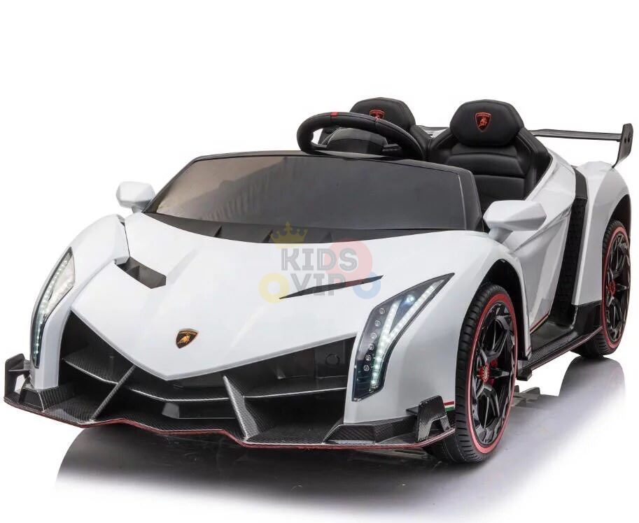 The White 2X12V Limited Edition 4WD Lamborghini Veneno Ride-on Car features a sleek, angular design with black accents, red-lined black wheels, a detailed front grille, LED-style headlights, and a black steering wheel. Its a stylish two-seater toy sports car.