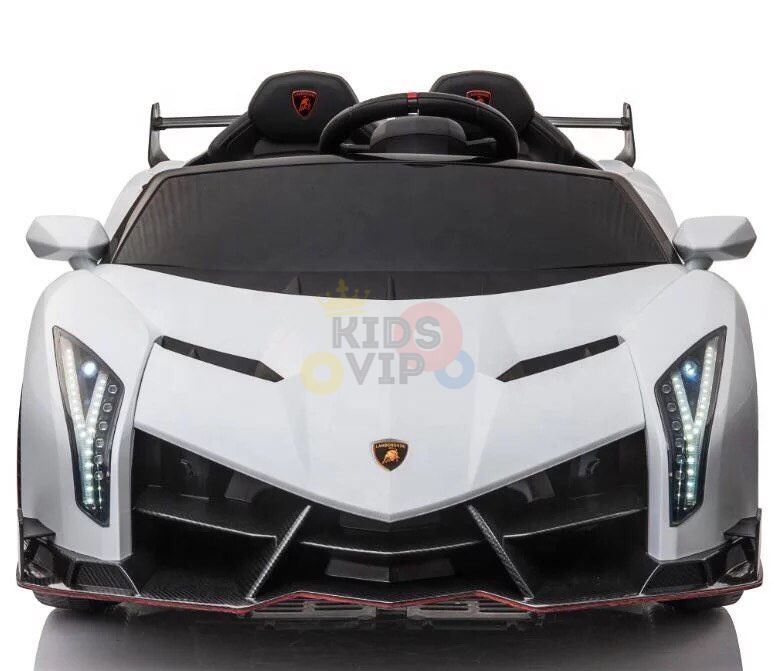 The White 2X12V Limited Edition 4WD Lamborghini Veneno Ride-On Car features sleek lines, LED-style headlights, a prominent rear wing, angular front design, and Kids VIP on the windshield. Its a stylish 2-seater resembling the real Lamborghini Veneno.