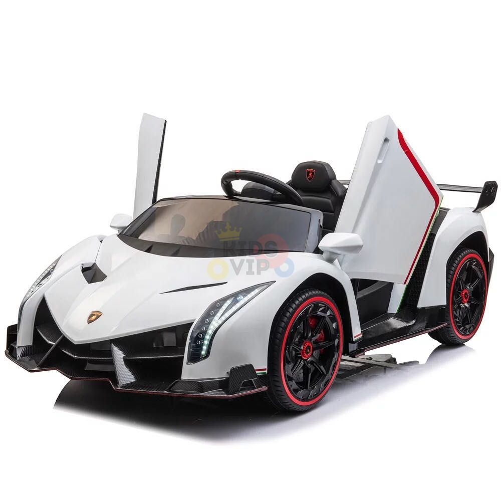 The White 2X12V Limited Edition 4WD Lamborghini Veneno Ride-on Car, RC features Lamborghini-style upward-opening doors, LED headlights, black wheels with red rims, detailed interior, and a logo-adorned steering wheel. This sporty 2-seater ensures thrilling adventures.