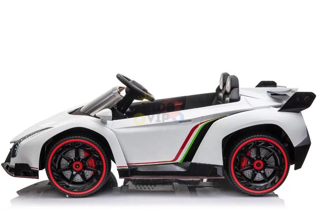 The White 2X12V Limited Edition 4WD Lamborghini Veneno Ride on Car, RC, is a stylish white car with red and black accents. This 2-seater includes a steering wheel, sporty wheels, an aerodynamic body, and a rear spoiler for added flair.
