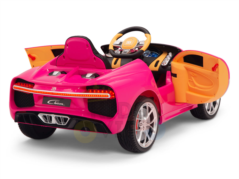 The Pink 12V Bugatti Chiron Kids Licensed 1 Seater Ride On Car mimics a luxury sports car with open orange doors, a small steering wheel, realistic dashboard, detailed headlights and taillights, sturdy rubber wheels, and remote control for added fun.