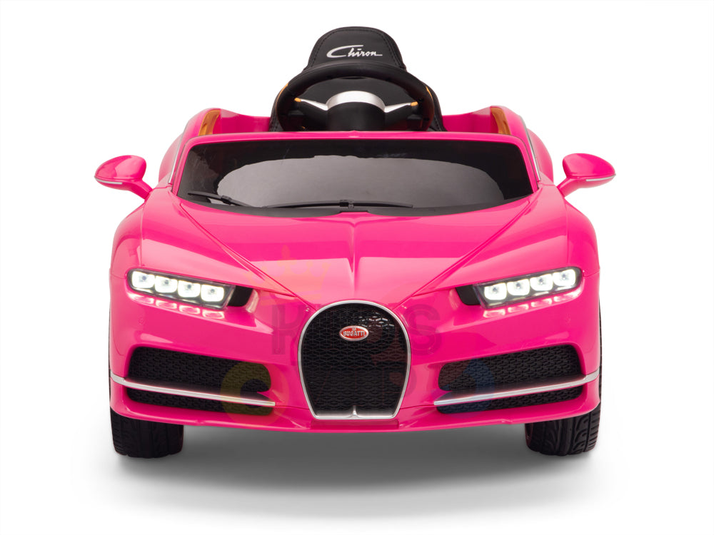The Pink 12V Bugatti Chiron Kids Licensed 1 Seater Ride On Car boasts a sleek design, detailed headlights, a black seat, and a front grille logo. Its rubber wheels guarantee smooth rides for young speed enthusiasts.