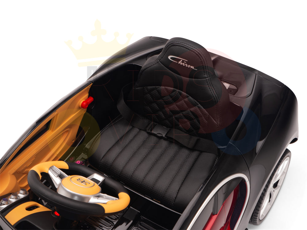 The Red 12V Bugatti Chiron Kids Ride On Car features EVA rubber wheels and a detailed black interior with stitched seats labeled Chiron. Its steering wheel includes buttons, and the sleek dashboard mimics the iconic Bugatti style.