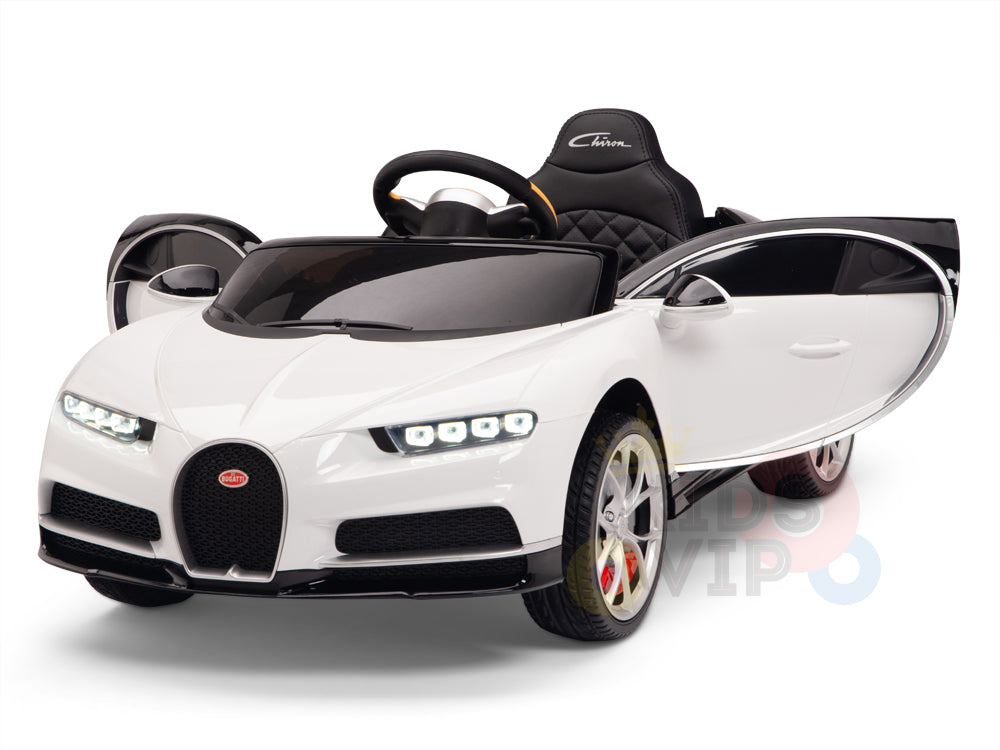 The White 12V Bugatti Chiron Kids Licensed 1 Seater Ride On Car with Rubber Wheels features detailed headlights, an open door, black steering wheel, and quilted black seat. Its sleek aerodynamic design and rubber wheels ensure smooth rides.