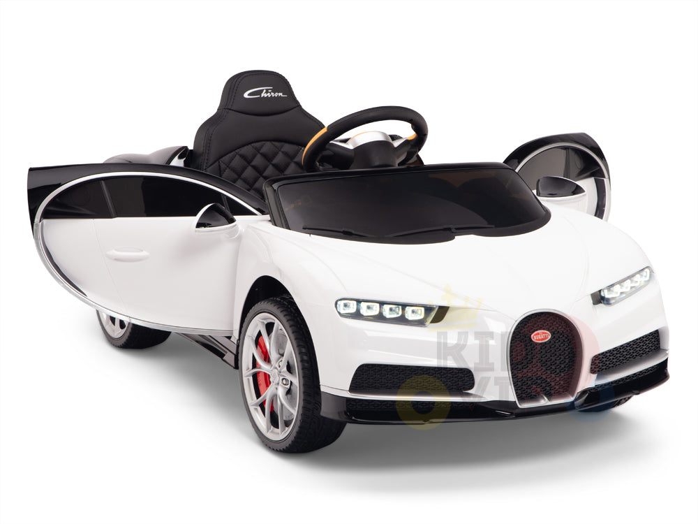 The White 12V Bugatti Chiron Kids Licensed 1 Seater Ride On Car features a sleek sports design, open doors, quilted black seats, detailed headlights, a curved windshield, rubber wheels for smooth rides, and visible branding on the seat.