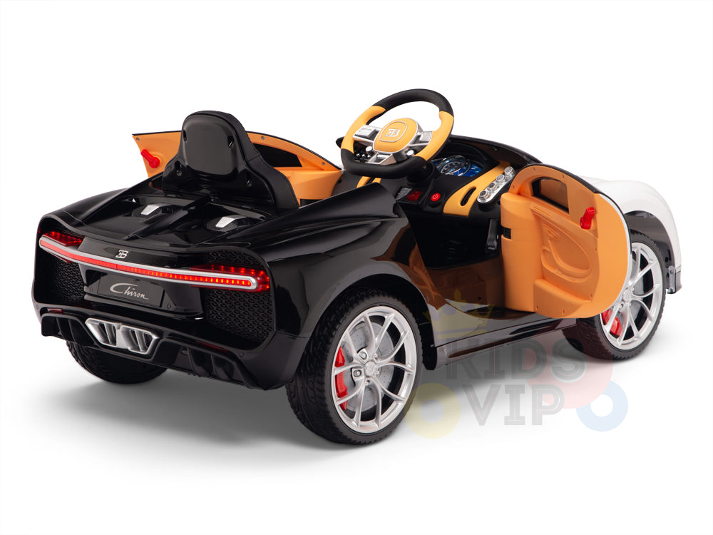 A white 12V Bugatti Chiron Kids Licensed 1-seater ride-on car, featuring rubber wheels and a detailed steering wheel, resembles a sleek luxury sports car with open doors.