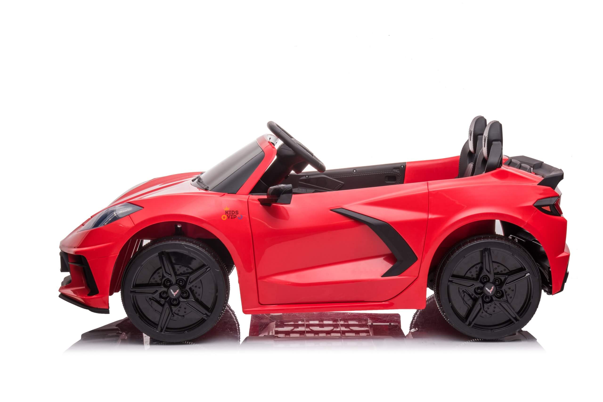 The Kids Premium 24V Red Corvette C8 Dual-Seater is a toy convertible car with black EVA wheels and leather seats. It features a sleek design with aerodynamic accents, viewed side-on against a white background, ideal for kids to enjoy.