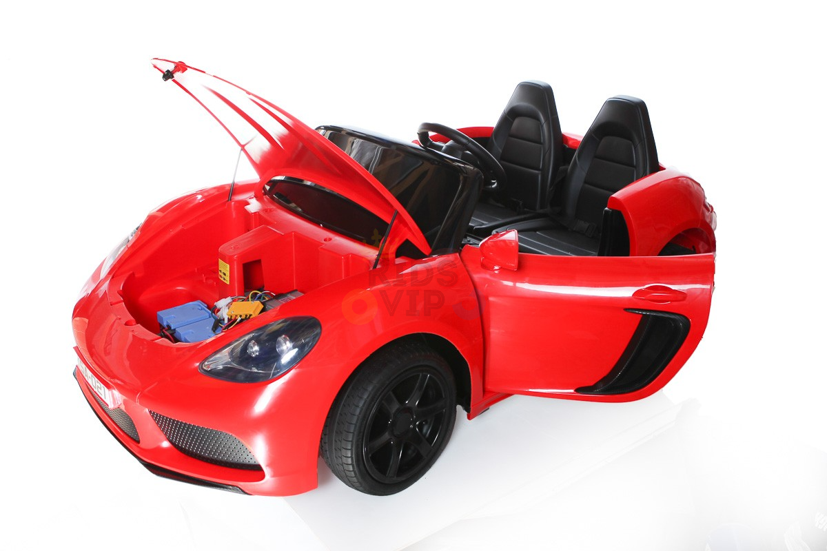 The Red 24V XXL SuperSport Big Kids Ride On Car features an open hood, revealing its internal components and a 180W brushless motor. It has two black seats, sleek black wheels, and one open door against a crisp white backdrop.