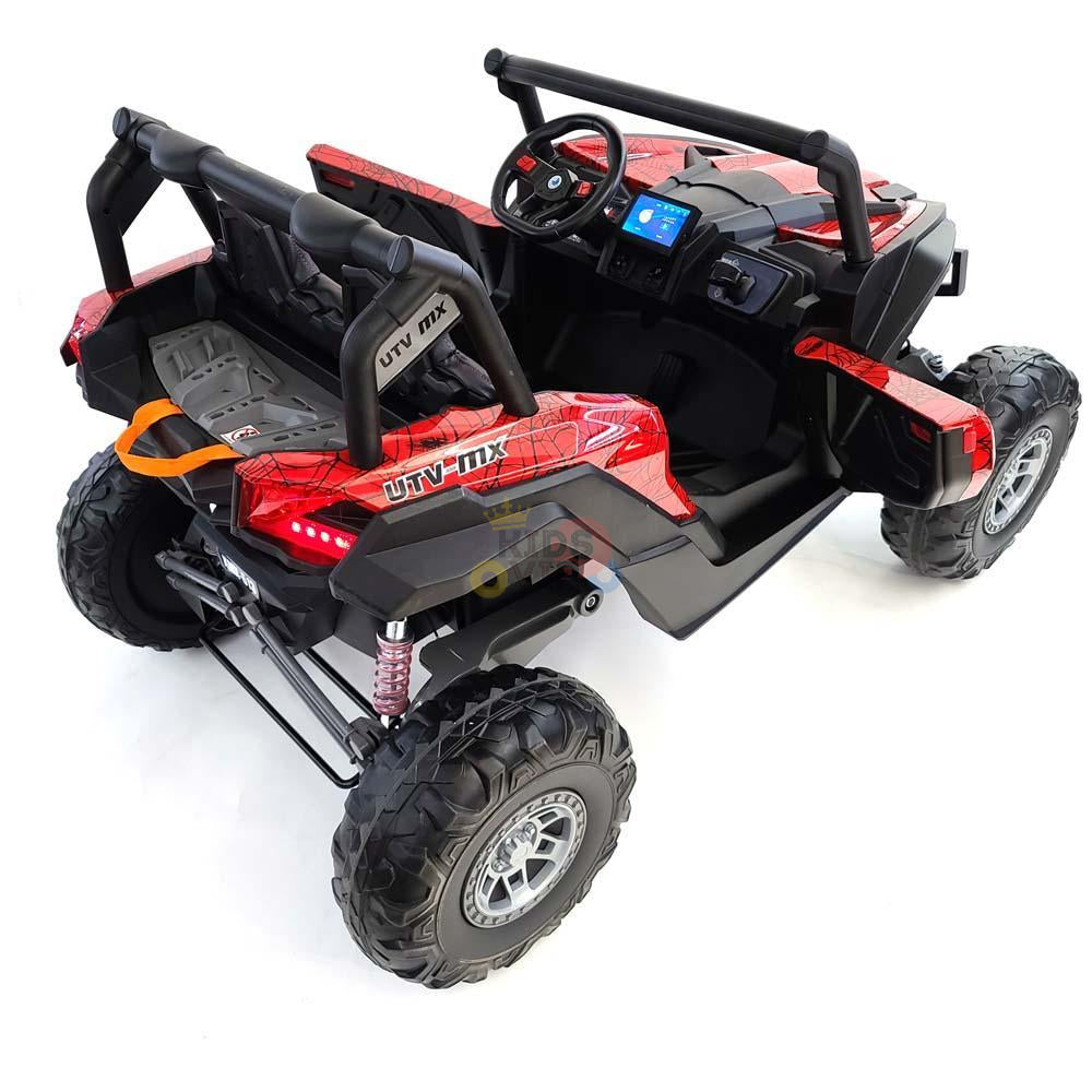 The Spyder Red XXL 24V MX Buggy MP4 Edition is a rugged UTV ride-on with RC, featuring a sturdy frame, rubber off-road tires, steering wheel, dashboard controls, and two seats with safety harnesses for adventurous young explorers.