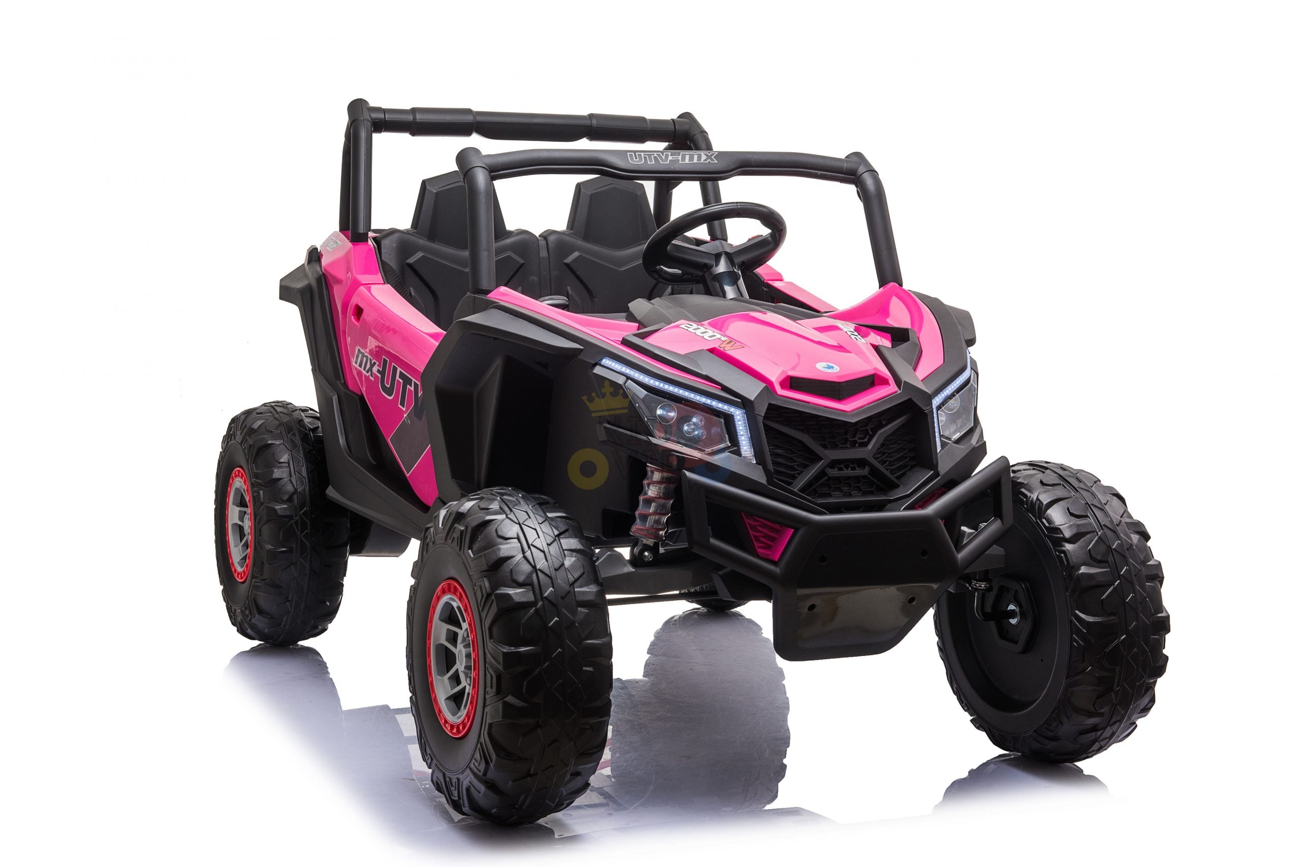 The Pink XXL 2 Seats Challenger MX Buggy 24V Edition is a toy off-road vehicle with rubber wheels and a steering wheel. Featuring UTV on the side, its sporty look is ideal for adventurous kids as a ride-on car.