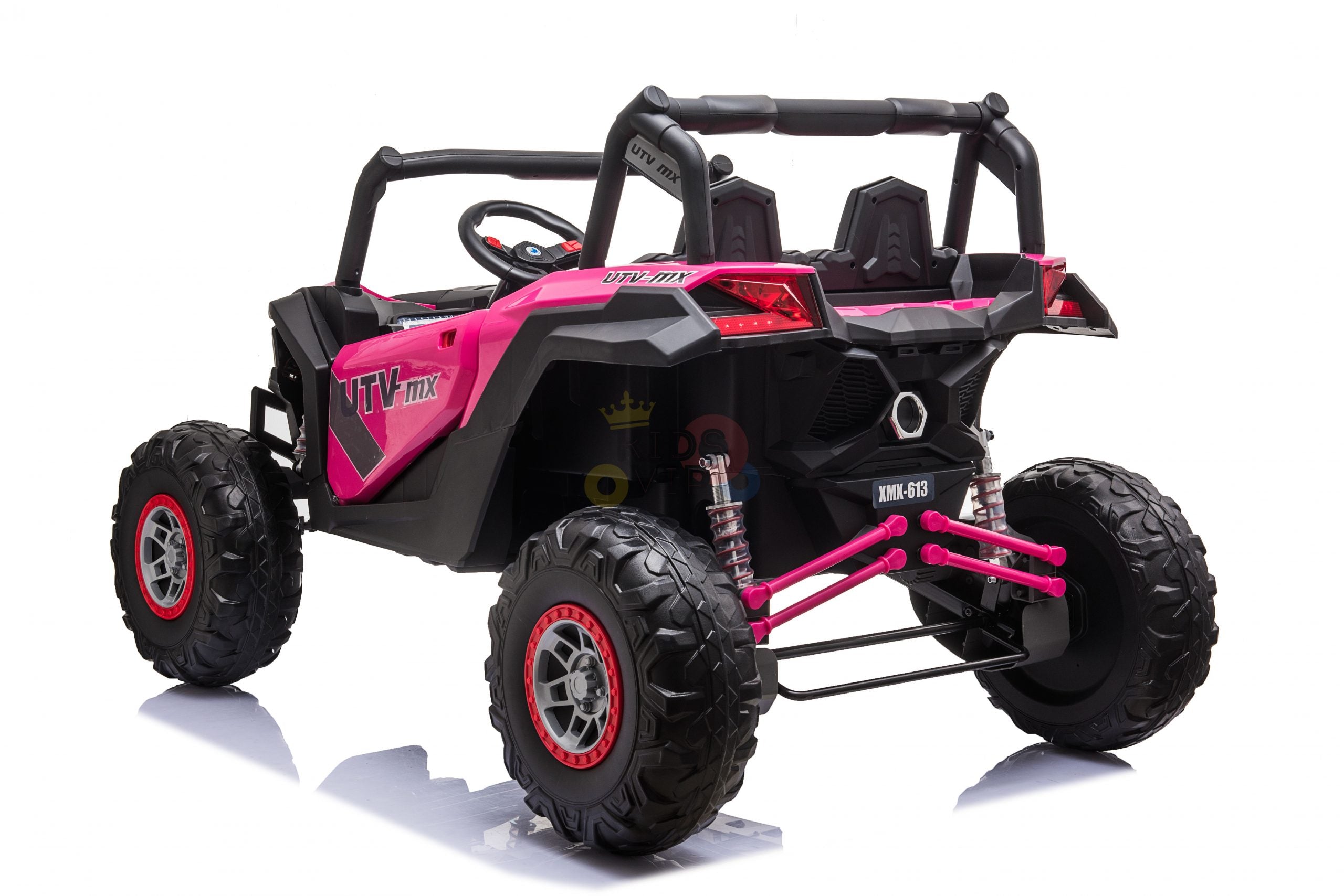 The Pink XXL 2 Seats Challenger MX Buggy 24V Edition Kids Ride On Car features large rubber wheels and detailed rear suspension, designed for thrilling off-road adventures. Positioned at an angle on a reflective white surface, its steering wheel hints at excitement ahead.