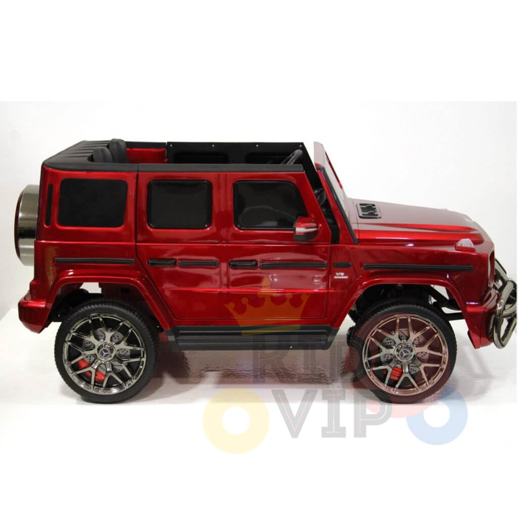 The Special LED Edition Mercedes G Series 24V Kids Ride On, a toy model SUV, features a red body with detailed touches like large silver wheels, open side doors, and a rear spare tire, all set against a white background.