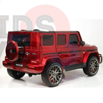 A glossy red toy car, resembling a luxury SUV, mirrors the Special LED Edition 2 Seats 4WD 24V Mercedes G Series Kids Ride On w/RC. It features large chrome wheels, angular windows, and a rear spare tire, complete with Parental Remote Control against a white background.