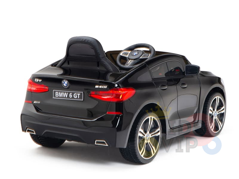 The Black Licensed BMW GT 12V Kids Ride On Power Car with Remote Control features a realistic design, detailed steering wheel, side mirrors, chrome-accented wheels, and a supportive raised backrest. Young drivers will love this official ride-on car.