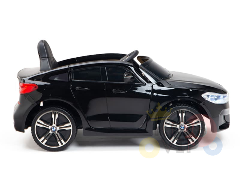 The Black Licensed BMW GT 12V Kids Ride On Power Car with Remote Control is a sleek black toy sports car featuring upgraded design elements, including a shiny exterior, detailed features, a small seat, steering wheel, and realistic wheels and headlights for an authentic driving experience.