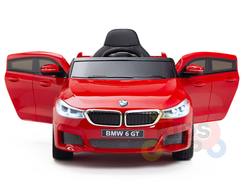 The Red 12V BMW GT Kids Licensed 1 Seater Ride-On Car features rubber wheels, operable doors, detailed design, and headlights. Perfect for little luxury enthusiasts enjoying electric ride-on adventures.