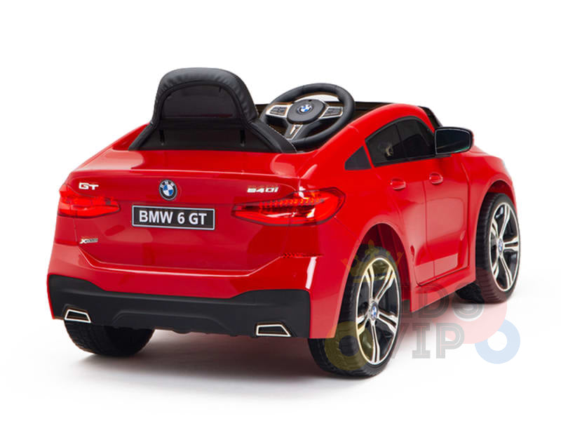 The Red 12V BMW GT Kids Licensed 1 Seater Ride On Car, shown from the rear left, features a black racing seat, steering wheel, realistic details, and an electric ride-on function. BMW 6 GT is prominently displayed on the back.