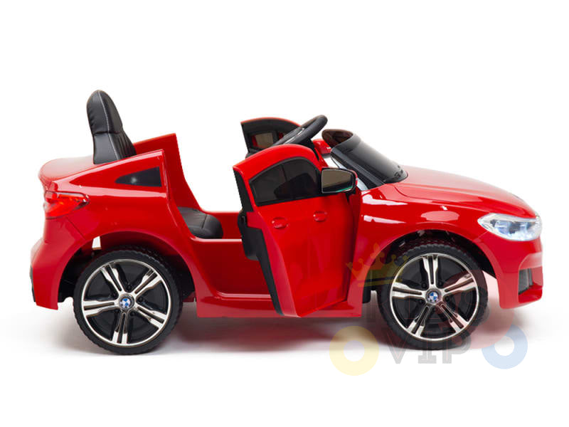 The Red 12V BMW GT Kids Licensed 1 Seater Ride On Car features open doors resembling a convertible, large black and silver wheels, a black seat, and visible steering wheel. This electric ride-on comes with rubber wheels and remote control—perfect for kids. White background.