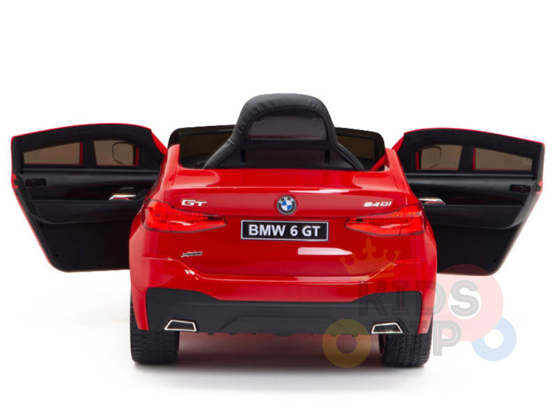 The Red 12V BMW GT Kids Licensed Ride-On Car is shown from the rear, featuring open doors, a sleek black seat, and a BMW 6 GT 240i license plate, all set against a crisp white background.