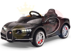 This 12V Black Bugatti Chiron Kids Licensed 1 Seater Ride On Car features sleek curves, detailed headlights, a visible front grille, silver wheels with red accents, and a hood logo. With rubber wheels and remote control, it exudes elegance and flair akin to the luxury sports car.