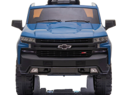 The Blue 12V Chevrolet Silverado Kids Licensed 1 Seater Ride On Truck is viewed from the front, showcasing its detailed grille, headlights, large tires, and interior features like a sporty design and small steering wheel for authenticity.
