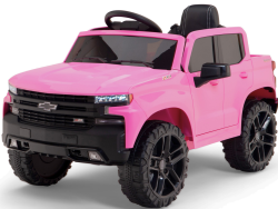 The Pink 12V Chevrolet Silverado Kids Licensed 1 Seater Ride On Truck features large black wheels and a detailed front grille. Its black interior and remote control make it ideal for children, showcased on a plain white background to highlight its bold design.