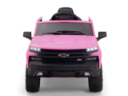 The Pink 12V Chevrolet Silverado Kids Licensed 1 Seater Ride On Truck is front-view photographed, boasting LED headlights, a sturdy bumper, and a black steering wheel. It includes remote control for fun and safety.