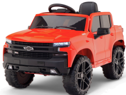 The Red 12V Chevrolet Silverado Kids Licensed 1 Seater Ride On Truck features a black interior, oversized wheels, detailed front grille, and lights. It mimics a real truck and includes remote control for adult supervision.