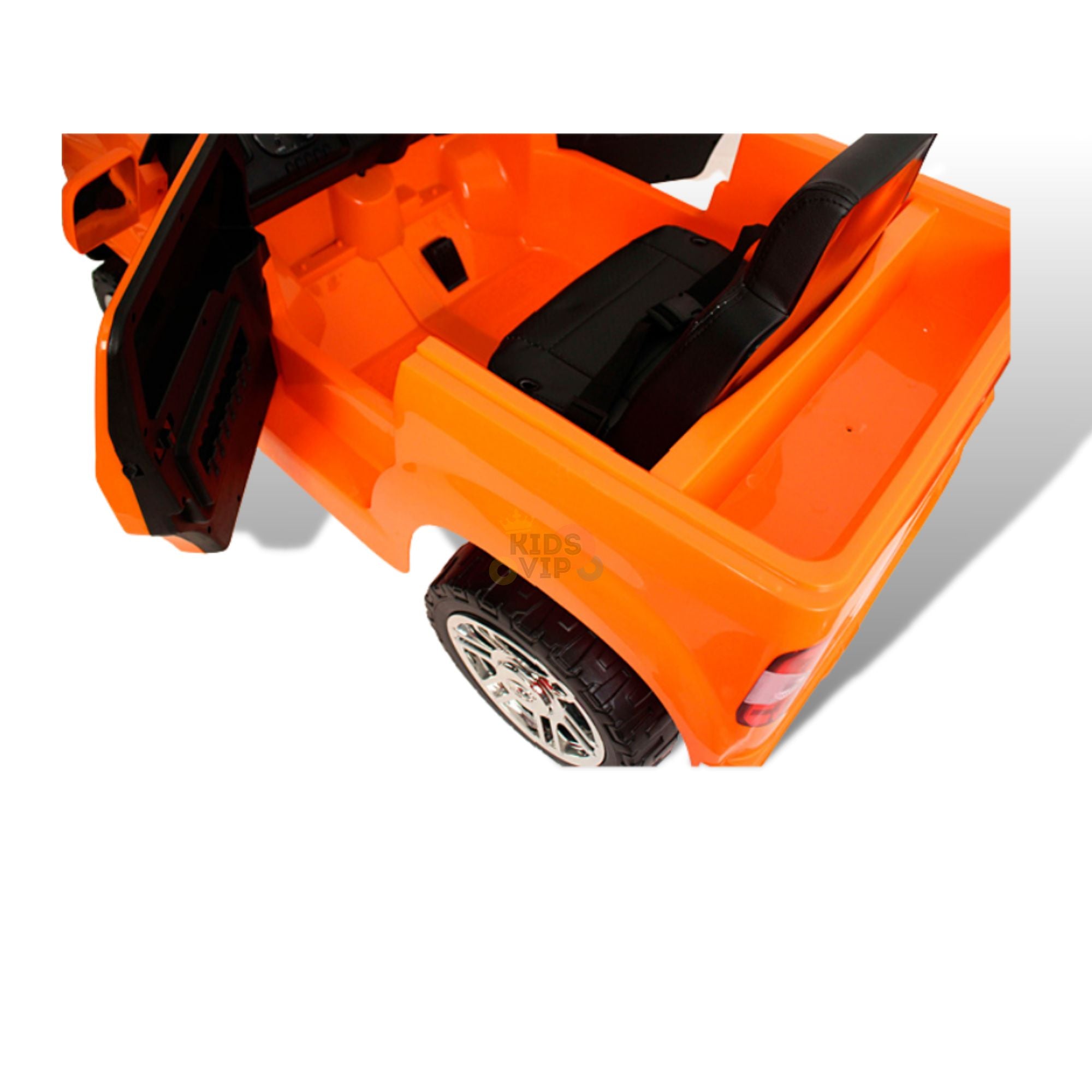 The Orange 12V Licensed Upgraded Toyota Tundra 1 Seater Kids Ride On Truck with RC features an open side door, revealing black seats and detailed wheels. Perfect for kids, its vibrant hue stands out against a white backdrop, and it runs on a 12V battery with an empty rear section.