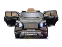 The Black Licensed Bentley Bentayga Complete Edition 12V Kids Ride-On Car features open front doors, detailed headlights, a BENTLEY license plate, tan leather seat interior, and realistic wheels. Its perfect for kids and includes a parental remote control.