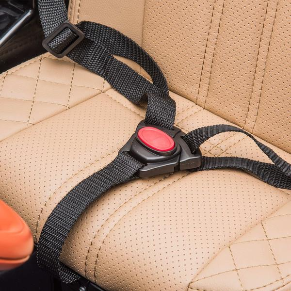 A close-up of a beige car seat with a diamond-stitched pattern, reminiscent of the White 12V Bentley Bentayga Kids Ride On Car, showcasing a black seatbelt secured into a red-topped buckle and partially displaying a black console on the left.
