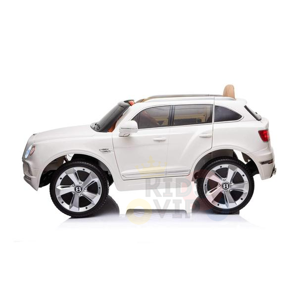 The White 12V Bentley Bentayga Kids Licensed 1 Seater Ride-On Car features rubber wheels, a detailed exterior, visible side mirrors, and includes a remote.