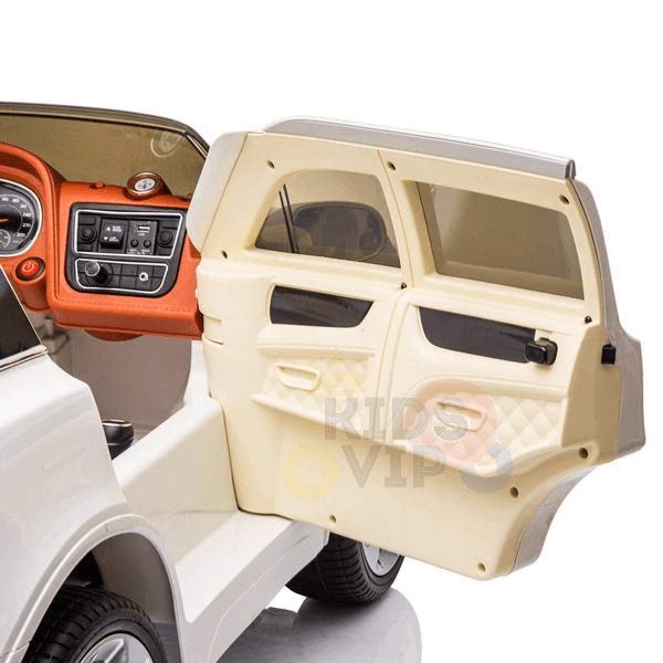 The White 12V Bentley Bentayga Kids Licensed 1 Seater Ride On Car features a detailed interior with an orange-accented dashboard, showing the steering wheel and control panel. Designed for children, it provides an exciting experience and includes rubber wheels and a remote.