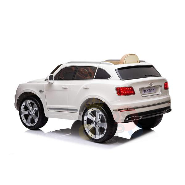 Introducing the White 12V Bentley Bentayga Kids Licensed 1 Seater Ride-On Car with Rubber Wheels and Remote, a sleek, luxury SUV model featuring detailed wheels, a rear spoiler, and a high-end brand logo.