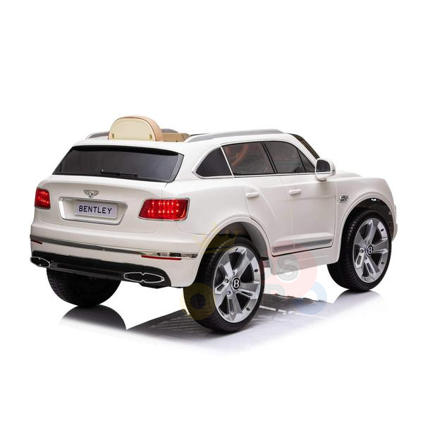 Discover the sleek elegance of the White 12V Bentley Bentayga Kids Licensed Ride On Car. Featuring detailed taillights and a BENTLEY plate, this toy car pairs realistic rubber wheels with remote control, igniting any childs dream of their own Bentley adventure.