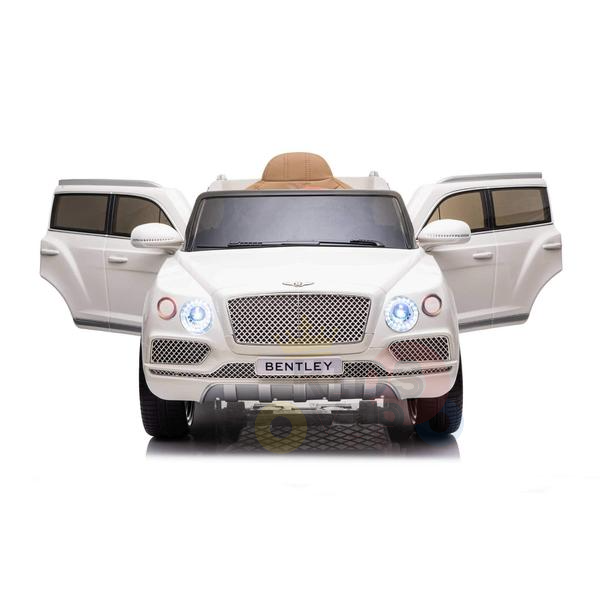 A White 12V Bentley Bentayga Kids Licensed Ride On Car, featuring rubber wheels and a remote, showcases open front doors, a detailed grille, and headlights against a plain white background.