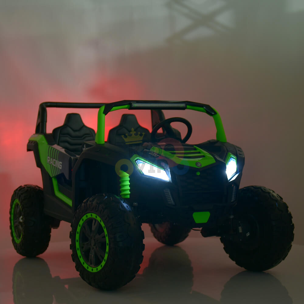 The 2 Seater XXL Blade BT 4WD Edition 24V Kids Ride On UTV mimics a rugged off-road vehicle with a sleek black body, bright green accents, large tires, and illuminated headlights for an exciting off-road experience against a misty backdrop.