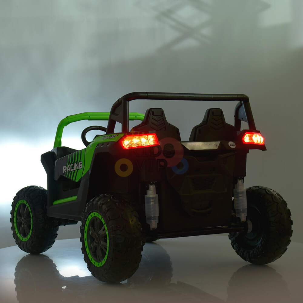 The 2 Seater XXL Blade BT 4WD Edition 24V Kids Ride On UTV, Buggy with RC features a green and black design with illuminated red rear lights. It includes large, rugged wheels, a roll cage with two seats, and rests on a reflective surface. The background is set against a neutral gradient.