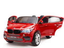 The Red 12V Licensed XXL BMW X6 Ride On Car with Remote Control boasts open doors, shining headlights, side mirrors, and a detailed front grille for style and functionality.